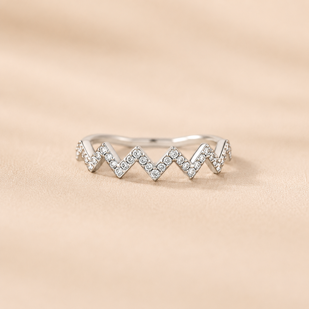 Silver-tone zigzag ring on beige background